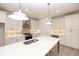 Bright eat-in kitchen featuring a large central island, pendant lighting, and stainless appliances at 707 Dodd N Ln # 164, Buford, GA 30518