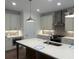 Gourmet kitchen featuring stainless steel appliances, a center island and stylish pendant lights at 707 Dodd N Ln # 164, Buford, GA 30518