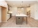 Bright eat-in kitchen features a central island, pendant lighting, and stainless steel appliances at 707 Dodd N Ln # 164, Buford, GA 30518