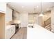 Bright kitchen with white cabinets, stainless steel appliances, a long island with a sink, and a staircase in the background at 707 Dodd N Ln # 164, Buford, GA 30518