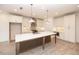 The eat-in kitchen features a large central island with pendant lighting and stainless appliances at 707 Dodd N Ln # 164, Buford, GA 30518
