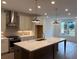 A modern kitchen with pendant lights, a large island, and stainless steel appliances at 707 Dodd N Ln # 164, Buford, GA 30518