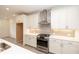 Kitchen featuring white cabinets, stainless steel appliances, modern fixtures, and tile backsplash, with an adjacent dining area at 707 Dodd N Ln # 164, Buford, GA 30518