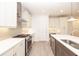Modern kitchen with white cabinets, stainless steel appliances, stylish backsplash, and a large island with a sink at 707 Dodd N Ln # 164, Buford, GA 30518