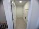 Functional laundry room equipped with tile floor, wire shelving and washer/dryer hookups at 707 Dodd N Ln # 164, Buford, GA 30518