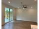 Living room with a ceiling fan and access to the outdoor patio through sliding glass doors at 707 Dodd N Ln # 164, Buford, GA 30518