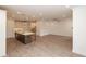 Open-concept living area with a kitchen island, hardwood floors, recessed lighting, and ample space for entertaining at 707 Dodd N Ln # 164, Buford, GA 30518