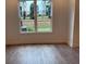 Bright living room area with hardwood floors and a large window with backyard views at 707 Dodd N Ln # 164, Buford, GA 30518