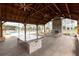 Relaxing outdoor pavilion with stone fireplace, wood ceiling, large table, and comfortable seating near pool at 707 Dodd N Ln # 164, Buford, GA 30518