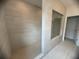 A spacious shower with a glass enclosure and honeycomb floor at 707 Dodd N Ln # 164, Buford, GA 30518