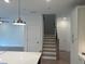 Interior shot of home with a staircase leading to the upper level and modern light fixtures at 707 Dodd N Ln # 164, Buford, GA 30518