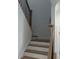 Staircase featuring wood treads, white risers and a dark iron railing that leads to upper floors at 707 Dodd N Ln # 164, Buford, GA 30518