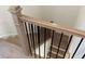 View from the top of a staircase featuring hardwood treads and sleek black iron balusters at 707 Dodd N Ln # 164, Buford, GA 30518