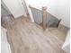 Bright staircase featuring hardwood floors and black metal railing at 707 Dodd N Ln # 164, Buford, GA 30518