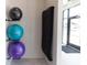 Well-lit yoga studio with fitness balls, black mats, and an exit to a parking lot at 707 Dodd N Ln # 164, Buford, GA 30518
