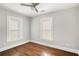 Bedroom with hardwood floors, a ceiling fan, neutral paint, and bright natural light streaming through two windows at 763 Jones Nw Ave, Atlanta, GA 30314