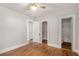 Bright bedroom with hardwood floors, neutral paint, a ceiling fan, and ensuite bathroom access at 763 Jones Nw Ave, Atlanta, GA 30314