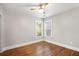Bright bedroom with hardwood floors, neutral paint, a ceiling fan, and two windows providing natural light at 763 Jones Nw Ave, Atlanta, GA 30314