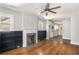 Open floor plan showcasing hardwood floors, fireplace, built in bookcases and natural light from the windows into kitchen at 763 Jones Nw Ave, Atlanta, GA 30314