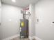 A well-lit utility room featuring a hot water tank, plus electrical and plumbing connections at 763 Jones Nw Ave, Atlanta, GA 30314