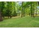 Lush green backyard featuring mature trees scattered across the lawn, providing shade and privacy at 789 Concord Sw Rd, Smyrna, GA 30082