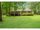 A spacious backyard with a deck offers a perfect outdoor living space amid lush greenery at 789 Concord Sw Rd, Smyrna, GA 30082