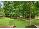 Lush backyard with mature trees seen from a wooden deck at 789 Concord Sw Rd, Smyrna, GA 30082