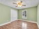 Cozy bedroom featuring wood floors, a ceiling fan, and a window for natural light at 789 Concord Sw Rd, Smyrna, GA 30082