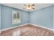 Charming bedroom with light blue walls, wood floors, and a bright window at 789 Concord Sw Rd, Smyrna, GA 30082