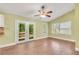 Bright dining area featuring hardwood floors, vaulted ceiling, ceiling fan, and access to the backyard at 789 Concord Sw Rd, Smyrna, GA 30082