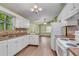 Bright kitchen featuring white cabinetry, updated appliances, laminate countertops, and access to backyard at 789 Concord Sw Rd, Smyrna, GA 30082