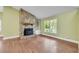 Bright living room with hardwood floors, stone fireplace, and large windows offering scenic views at 789 Concord Sw Rd, Smyrna, GA 30082
