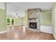 Spacious living room featuring hardwood floors, vaulted ceilings, a stone fireplace, and access to sunroom at 789 Concord Sw Rd, Smyrna, GA 30082
