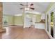 Open-concept living space with stone fireplace, dining area, and kitchen featuring white cabinets at 789 Concord Sw Rd, Smyrna, GA 30082
