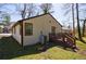 Backyard exterior featuring a wooden deck, siding, and lawn with tree stump at 141 Nathan Rd, Atlanta, GA 30331