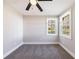 Cozy bedroom with soft carpet, ceiling fan, and abundant natural light from windows at 141 Nathan Rd, Atlanta, GA 30331