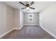 Bright bedroom features plush carpeting, a ceiling fan, and a large window at 141 Nathan Rd, Atlanta, GA 30331