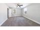 Inviting bedroom features neutral carpet, ceiling fan, and natural light from two windows at 141 Nathan Rd, Atlanta, GA 30331