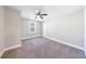 Cozy bedroom with soft carpet, ceiling fan, and a bright window at 141 Nathan Rd, Atlanta, GA 30331