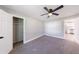 Bright bedroom with a ceiling fan, closet, neutral walls, and a glimpse into the kitchen at 141 Nathan Rd, Atlanta, GA 30331