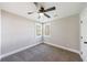 Bright bedroom features plush carpeting, a ceiling fan, and natural light from large windows at 141 Nathan Rd, Atlanta, GA 30331