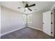 Inviting bedroom features neutral carpet, ceiling fan, and natural light from two windows at 141 Nathan Rd, Atlanta, GA 30331