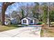 Exterior shot of the home with a large driveway and a view of the neighboring house at 141 Nathan Rd, Atlanta, GA 30331