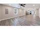 Open-concept living room and kitchen with sleek gray plank flooring and abundant natural light at 141 Nathan Rd, Atlanta, GA 30331