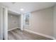 Bright room featuring vinyl plank flooring, a window, neutral walls, and modern trim at 141 Nathan Rd, Atlanta, GA 30331