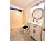 Bright half bathroom with vanity, decorative mirror, and shower-tub combo at 3793 Mays Sw Ct, Atlanta, GA 30331