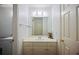 Bright bathroom featuring a large mirror, clean white fixtures, and modern lighting at 385 Guildhall Grv, Johns Creek, GA 30022