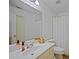 Well-lit bathroom featuring a single vanity, a large mirror, and a shower-tub combination at 385 Guildhall Grv, Johns Creek, GA 30022