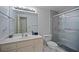 Well-lit bathroom featuring a glass-enclosed shower and vanity at 385 Guildhall Grv, Johns Creek, GA 30022