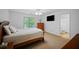 Bedroom with a queen bed, flat screen TV, and a window with natural light at 385 Guildhall Grv, Johns Creek, GA 30022